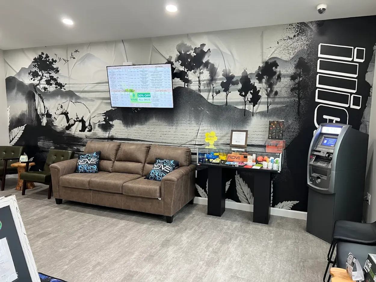 Modern cannabis dispensary lounge with comfortable seating, TV display, and decorative plants