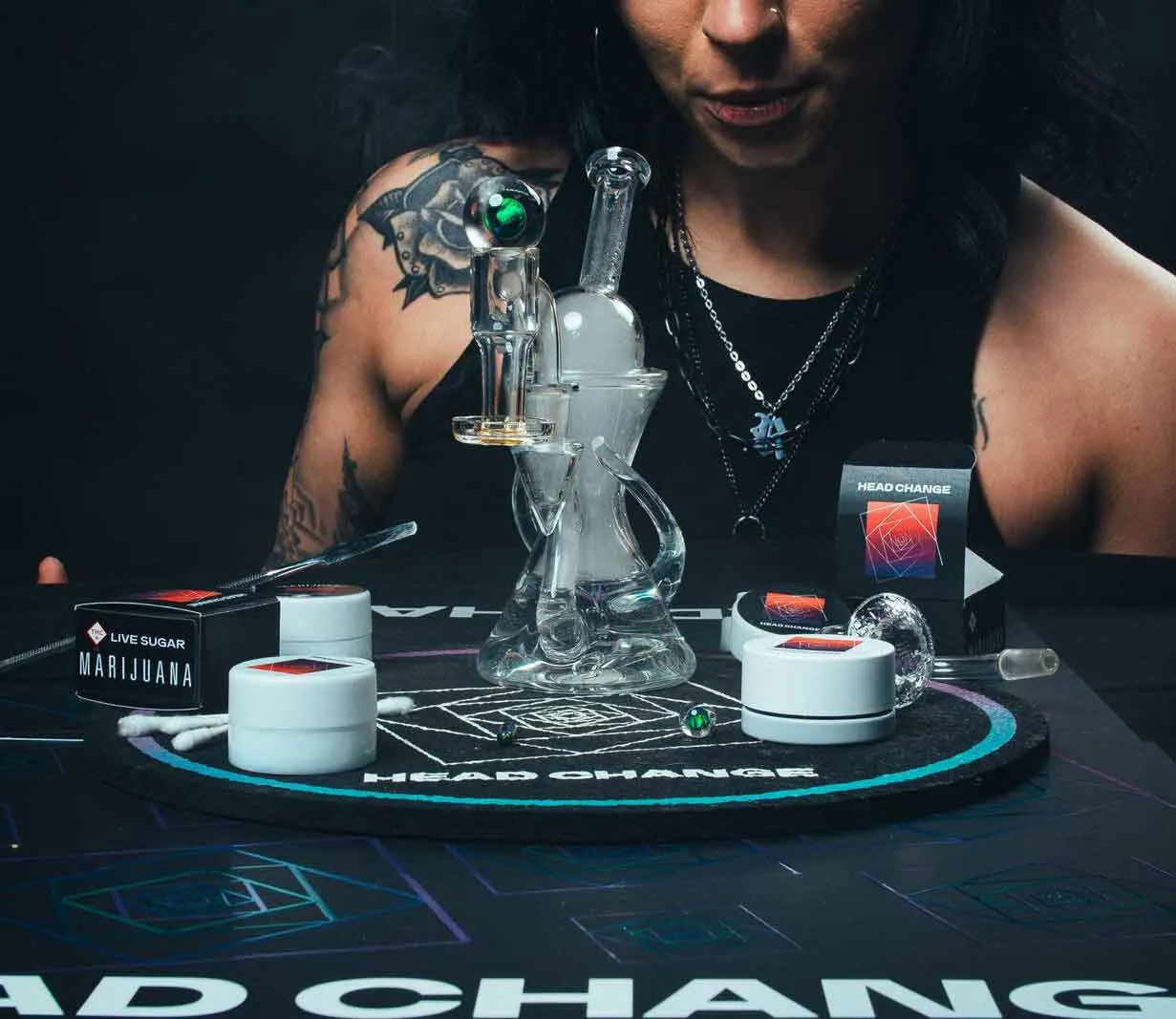 # Alt Text

Person pouring cannabis-infused beverage into glass cup on table with products displayed