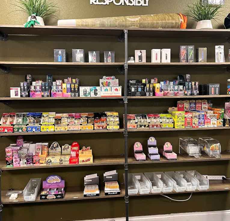 # Alt Text
Retail shelves displaying cannabis products, edibles, and accessories in organized dispensary display
