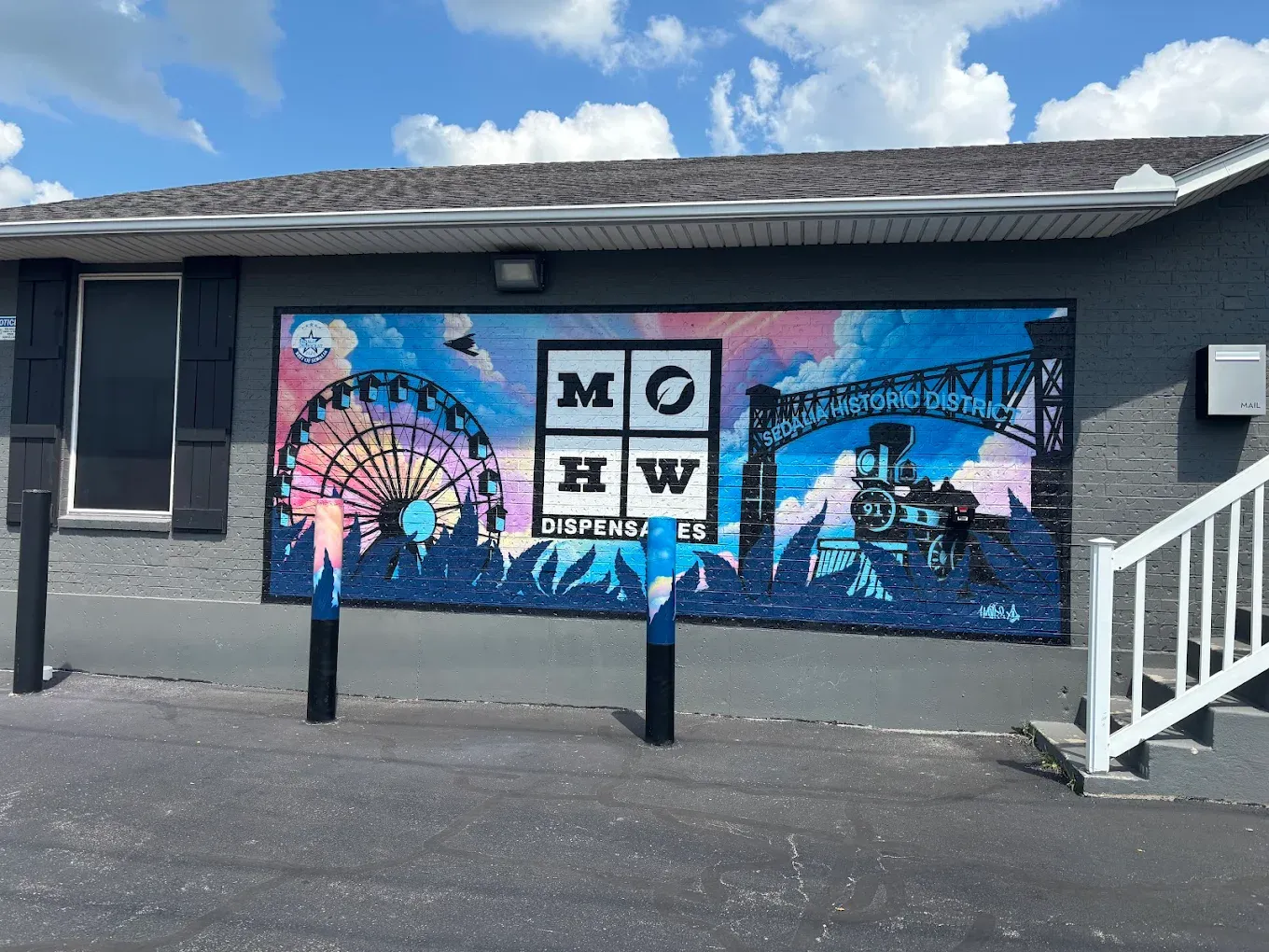 # Alt Text

Sedalia cannabis dispensary storefront with blue and pink branded murals on exterior wall