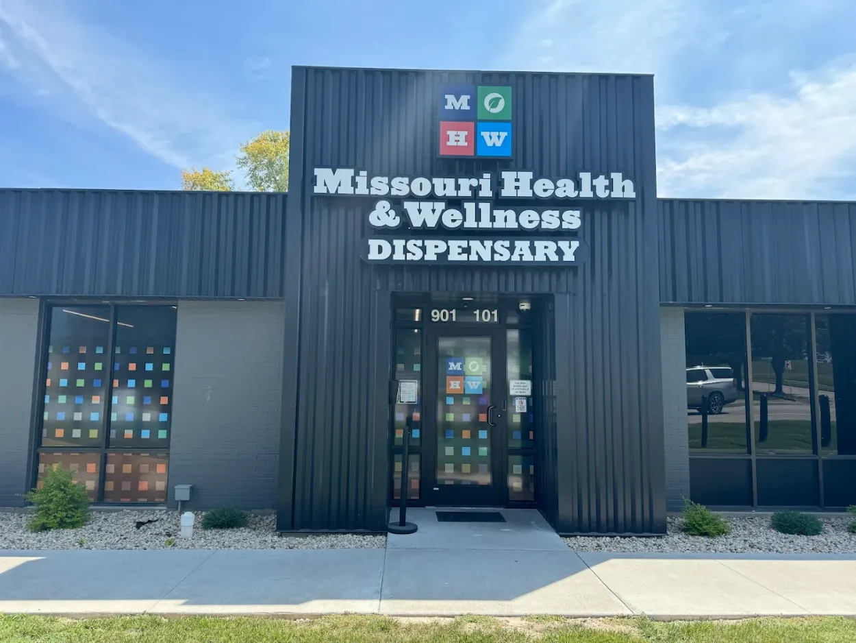 # Alt Text

Exterior storefront of Missouri cannabis dispensary with dark gray metal siding and entrance doors